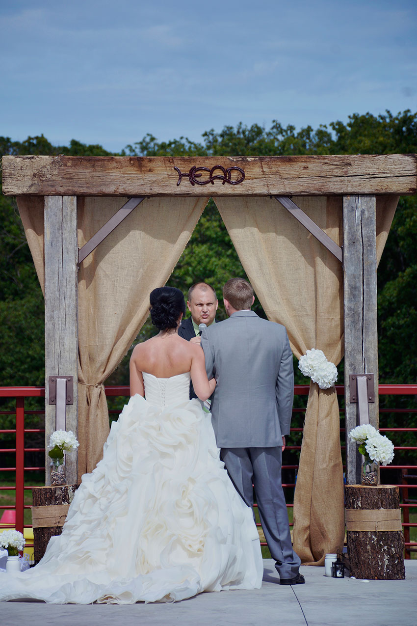 bride and groom at rustic altar at Seven T Farms outdoor st louis area wedding venue in sullivan missouri